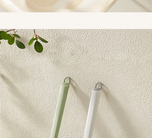 Detail of ergonomic plastic cleaning brush handles with hanging holes in green and gray