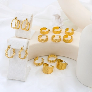 Detail view of various 18k gold plated chunky hoop earrings with textured finishes