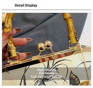 Detail of high-quality golden hardware and bamboo handle on the floral embroidery bag