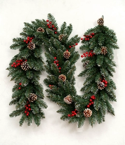 Close-up of premium Christmas garland with PE needles, red berries and pine cones
