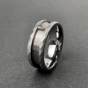 Detailed close-up of tungsten steel ring featuring hammer-textured edges and brushed surface