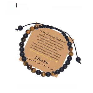 Morse code braided bracelet with tiger eye beads and matte stones on a gift card