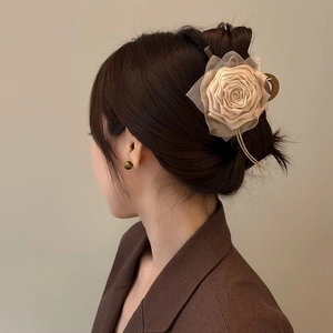 Beige fabric rose hair claw clip for women featuring elegant tulle petals on a metal base