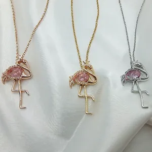 Elegant flamingo pendant necklace in gold and rose gold with a pink pear-shaped gemstone