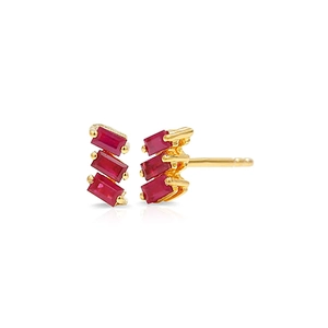 Macro view of gold stud earrings featuring three red rectangular step-cut gemstones
