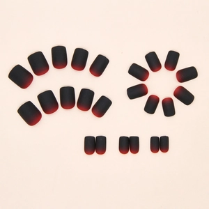 Detail of matte black and red gradient press-on nails in short square shape