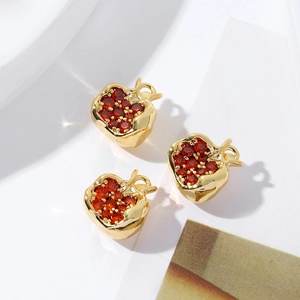 Macro detail of 18K gold plated apple charms with sparkling red cubic zirconia