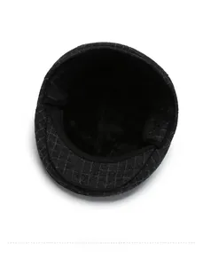 Detailed view of the thick warm plush lining inside a checkered winter newsboy cap