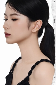 Detail of S925 sterling silver textured ear cuffs in gold and silver finish on ear