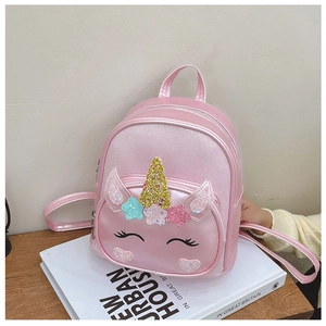 Detailed macro view of pink unicorn backpack with glitter horn and embroidery