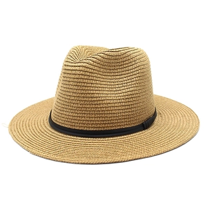 Detail of hand-woven straw Panama hat with fine texture and black ribbon band