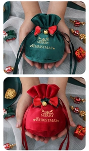 Detail of red and green velvet Christmas drawstring gift bags with gold foil reindeer prints