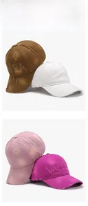 Close-up of distressed cotton baseball caps featuring vintage frayed edges and letter embroidery