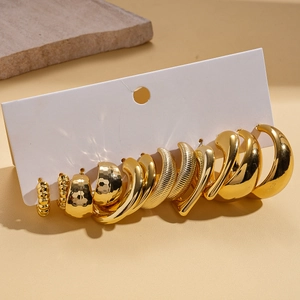 Close-up of 6 pairs golden chunky hoop earrings with various textures on display card