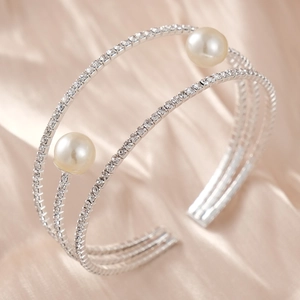 Detailed view of silver triple-layered cuff bracelet with rhinestones and pearls