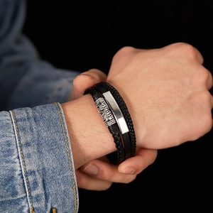 Close-up of black multilayer braided leather bracelet with silver magnetic metal clasp