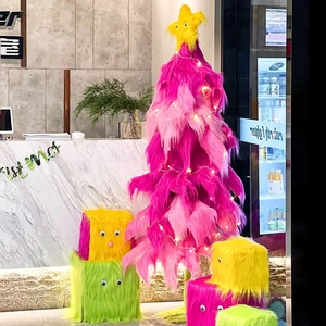 Close-up of pink faux fur Christmas tree and monster-style plush cubes with eye detail