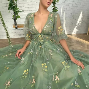 Elegant light green tulle prom dress featuring floral embroidery and puff sleeves