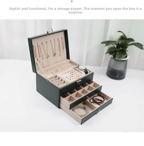 Three-layer dark green leather jewelry box with multiple drawers and velvet lining