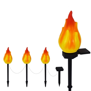 Solar outdoor garden flame lights set with four decorative stake lamps on white background