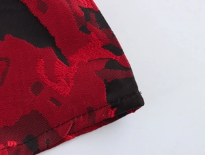 Macro shot of elegant red and black jacquard fabric with detailed floral texture