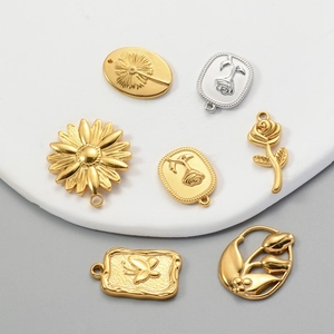 Golden and silver flower pendants in rose and sunflower designs for DIY jewelry making