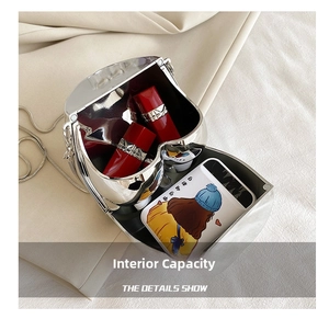 Interior capacity view of shiny silver metal chain bag showing storage for lipsticks