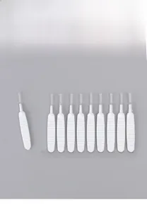 Macro detail of row-packed white shower head cleaning brushes with anti-slip handles