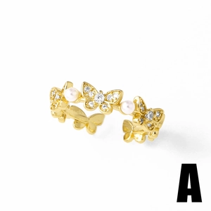 Gold open ring featuring delicate butterfly charms with small diamonds and round pearls