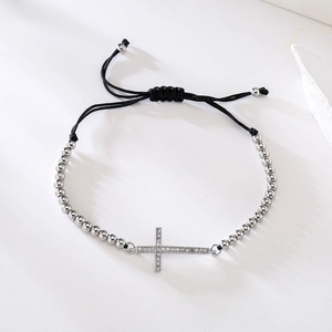 Silver beaded drawstring bracelet with sparkling zircon cross pendant on a white background