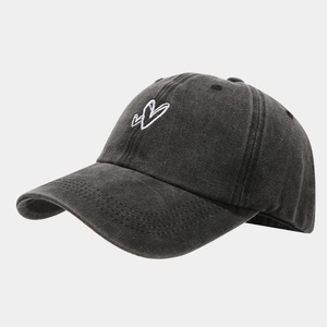 Close-up of vintage washed cotton baseball cap featuring white heart embroidery details