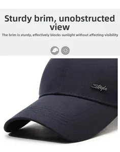 Detail of navy blue twill baseball cap with rigid brim and metal Style emblem