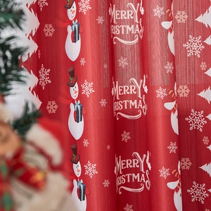 Detail of red Christmas curtain featuring snowman prints and Merry Christmas text