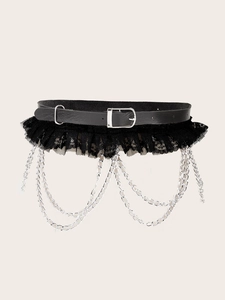 Detail of black leather corset belt with lace hem and silver punk chains decor