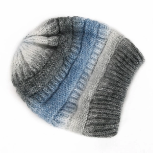 Detailed close-up of gradient stripe knit pattern on warm winter beanie hat texture