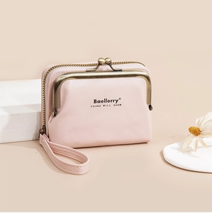 Detailed view of pink lychee textured wallet with metal kiss lock and wrist strap