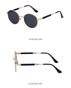 Detail view of round vintage sunglasses with gold metal frame and dark lenses
