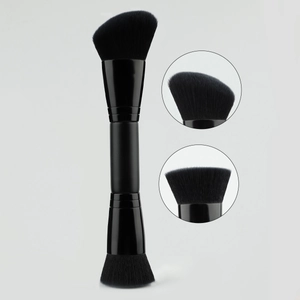 Detailed macro view of dual-ended black makeup brush with angled and flat foundation heads
