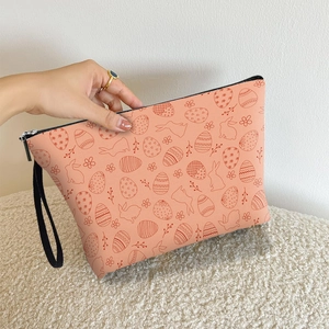 Peach Easter bunny makeup bag with double-sided rabbit prints and black zipper handle