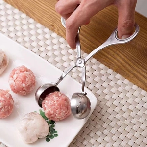 Stainless steel meatball maker tool forming a perfect meat ball in a kitchen setting
