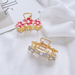 Elegant pearl flower alloy hair claws in pink and blue on white silk background