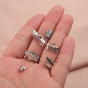 Various sizes of silver stainless steel ribbon crimp ends with textured grip for jewelry