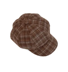 Top-down view of a vintage brown plaid newsboy cap with classic eight-panel structure