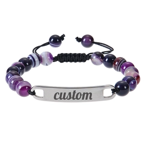 Detail of adjustable purple stone bead bracelet with custom engraved metal plate