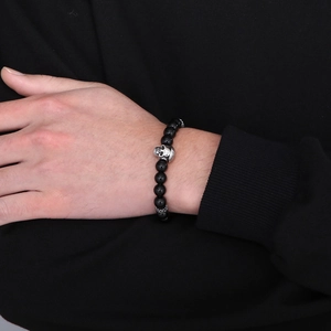 Mens beaded bracelet with tiger eye stones and silver skull charm on male wrist