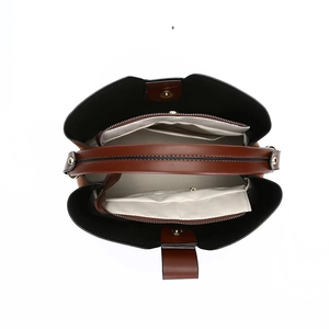Top view of large brown suede tote bag showing internal compartments and zipped pockets