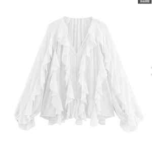 Detail of white ruffle blouse featuring a deep V-neckline and layered chiffon decorations