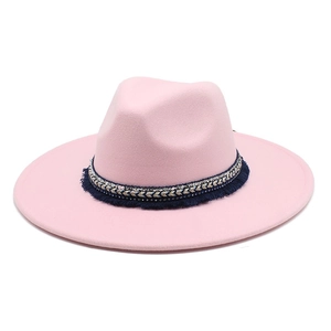 Close-up of pink felt fedora featuring ethnic style woven band and blue fringe detail