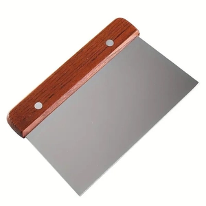 Stainless steel dough scraper with wooden handle and rivet fixation on white background