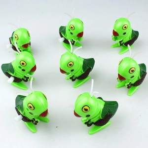 Top view of eight wind-up green grasshopper toys with colorful details on white background
